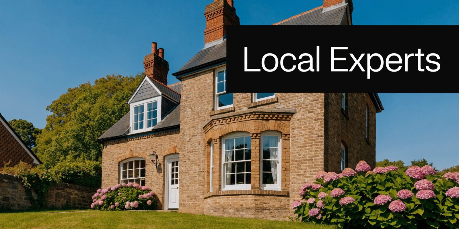A classic brick house with blooming hydrangea flowers, a manicured lawn, and a clear blue sky background.