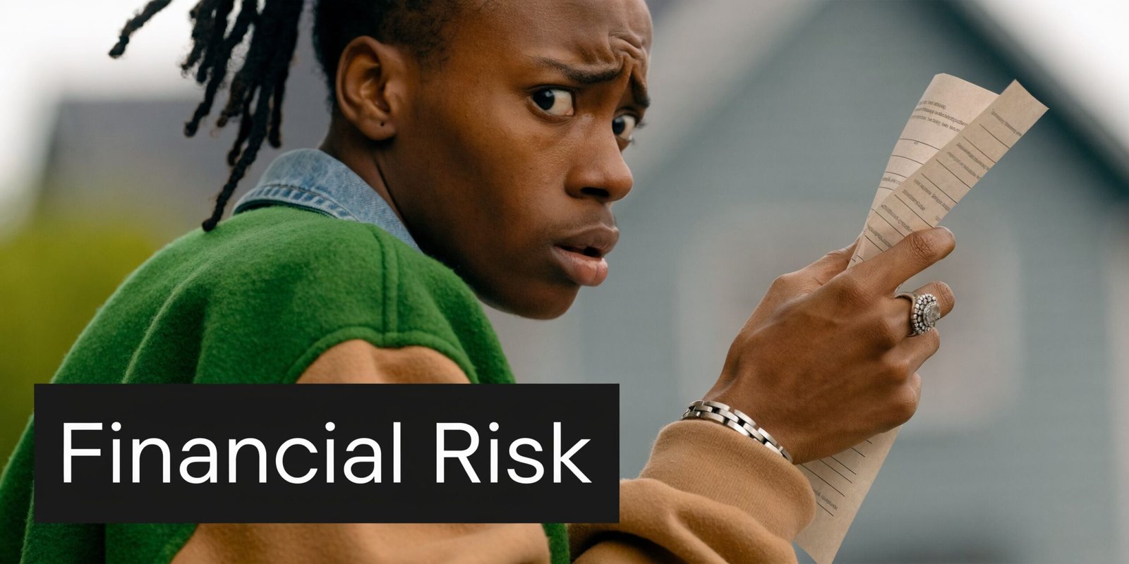 A concerned person holding a document, representing the stress and worry associated with potential financial risk.